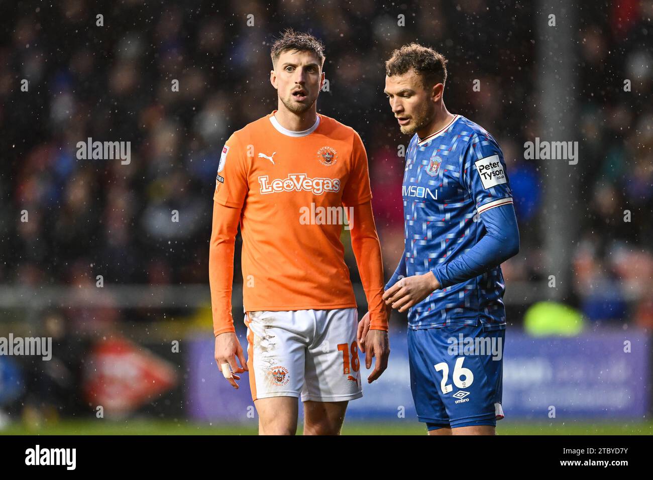 Jake Beesley #18 of Blackpool and Ben Barclay #26 of Carlisle United during the Sky Bet League 1 match Blackpool vs Carlisle United at Bloomfield Road, Blackpool, United Kingdom, 9th December 2023  (Photo by Craig Thomas/News Images) Stock Photo