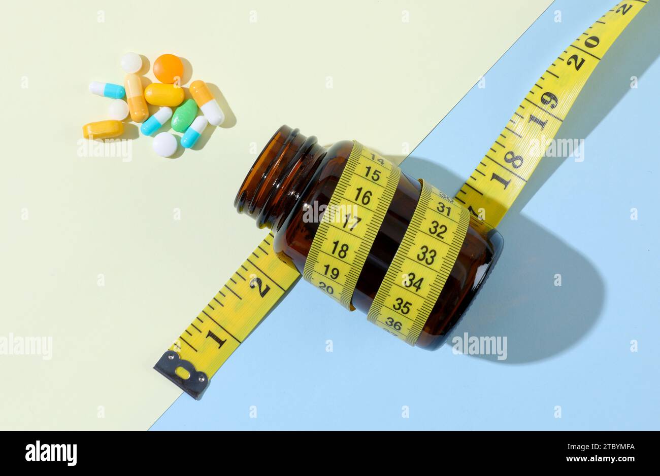 Diet pills and bottle of diet supplements with measuring tape Stock Photo
