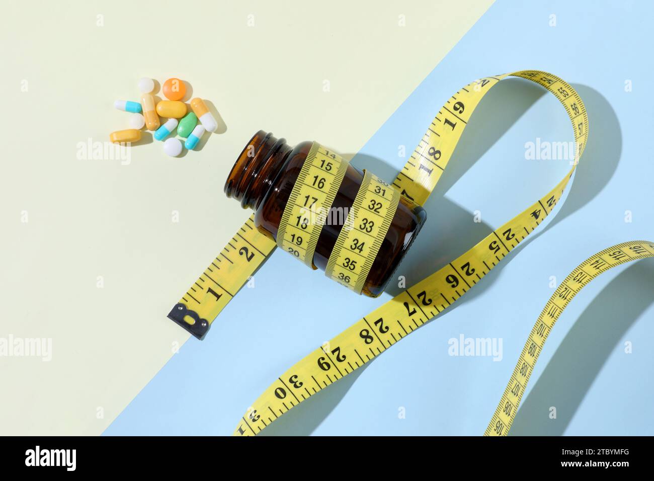 Diet pills and bottle of diet supplements with measuring tape Stock Photo