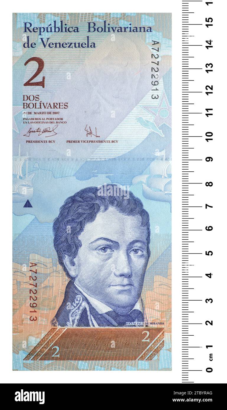 The front side of the Venezuelan banknote is two bolivars with a scaling ruler. Isolated on white Stock Photo