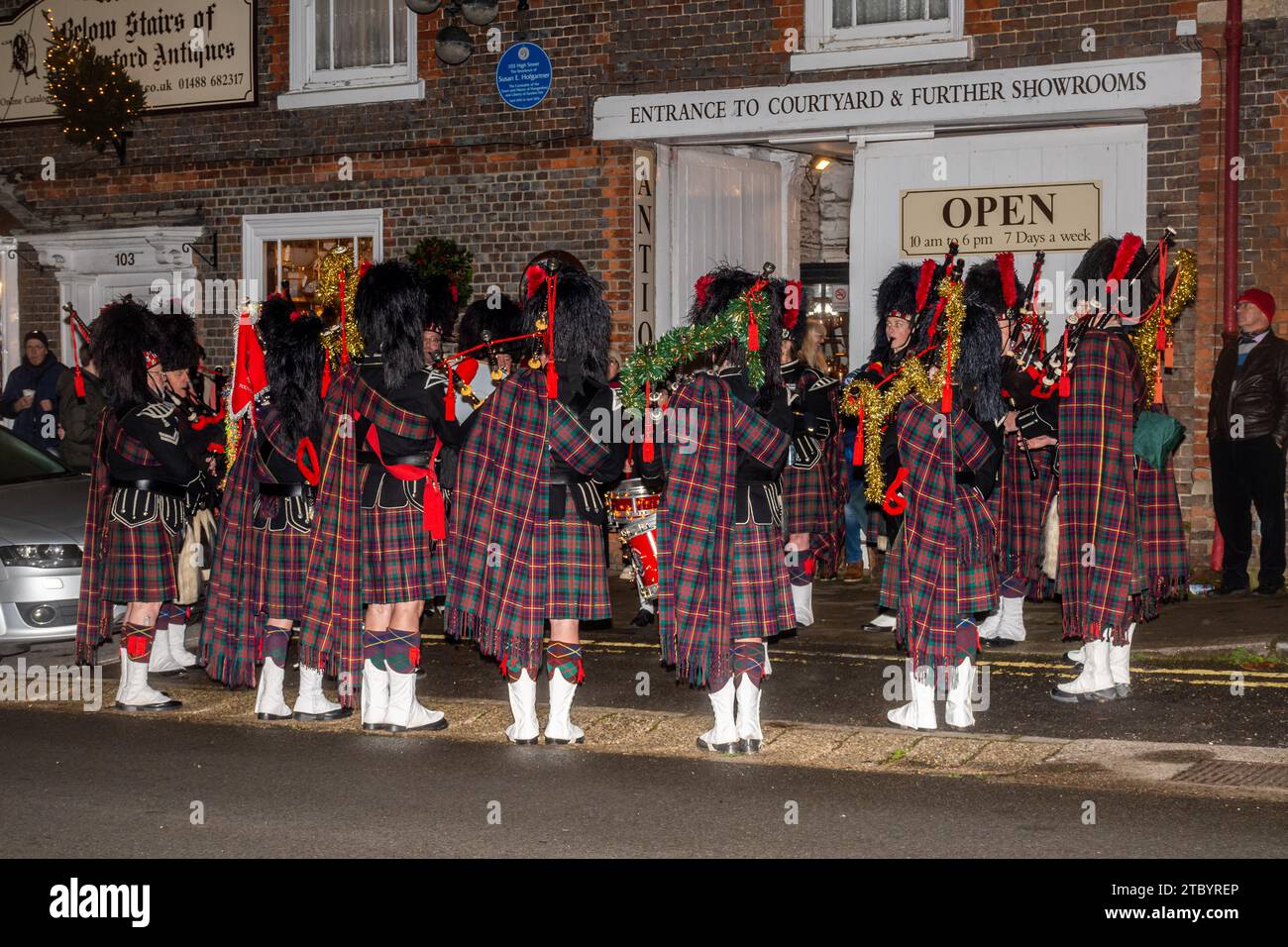 8th December 2023. The Hungerford Victorian Extravaganza, an annual Christmas event, took place in the West Berkshire town, England, UK. The evening features a parade, with Christmas street fair, festive music, food and drinks and steam engines. Pictured: Reading Scottish Pipe Band playing bagpipes and entertaining people. Stock Photo