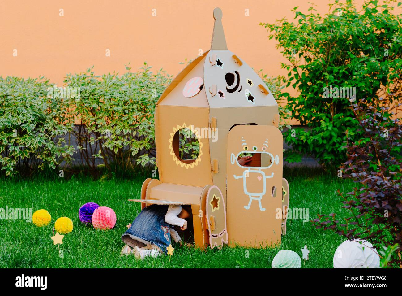 Children are having fun at cardboard rocket Stock Photo - Alamy
