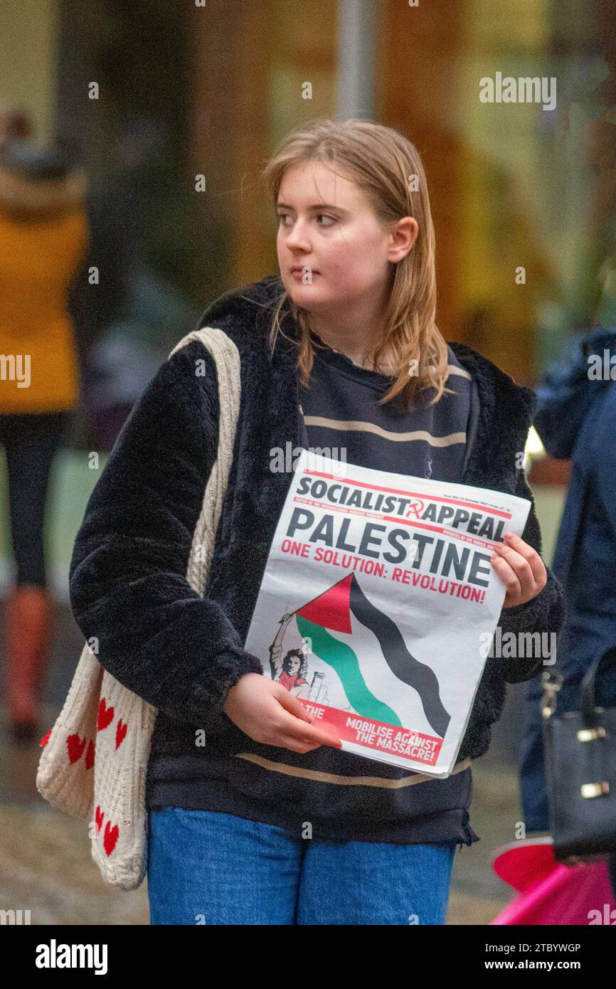 Socialist Appeal Preston, UK. 8 Dec 2023. Pro-Palestine forum posters. Socialist Appeal is the British section of the International Marxist Tendency. Join the Communists. Young women protesters with posters pamphlets & publications demonstrate against the Israel-Hamas war in the city centre. Credit: ZarkePix/Alamy Live News Stock Photo