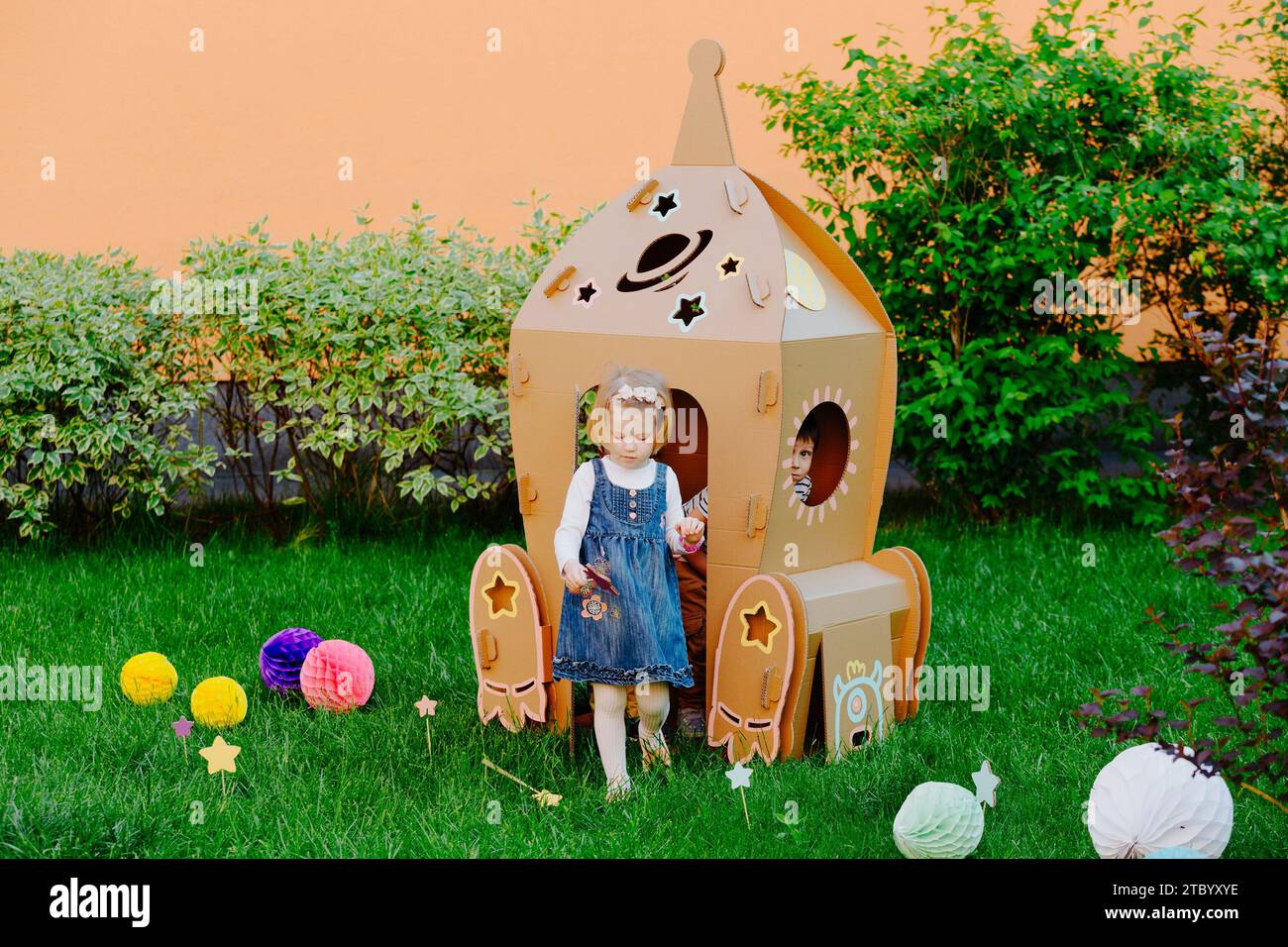 Children are having fun at cardboard rocket Stock Photo - Alamy
