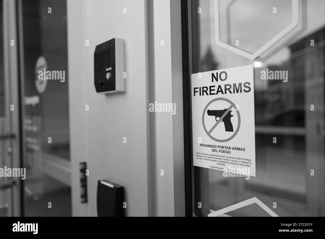 No Firearms sign on the entrance to a bank building in Flint Michigan USA Stock Photo