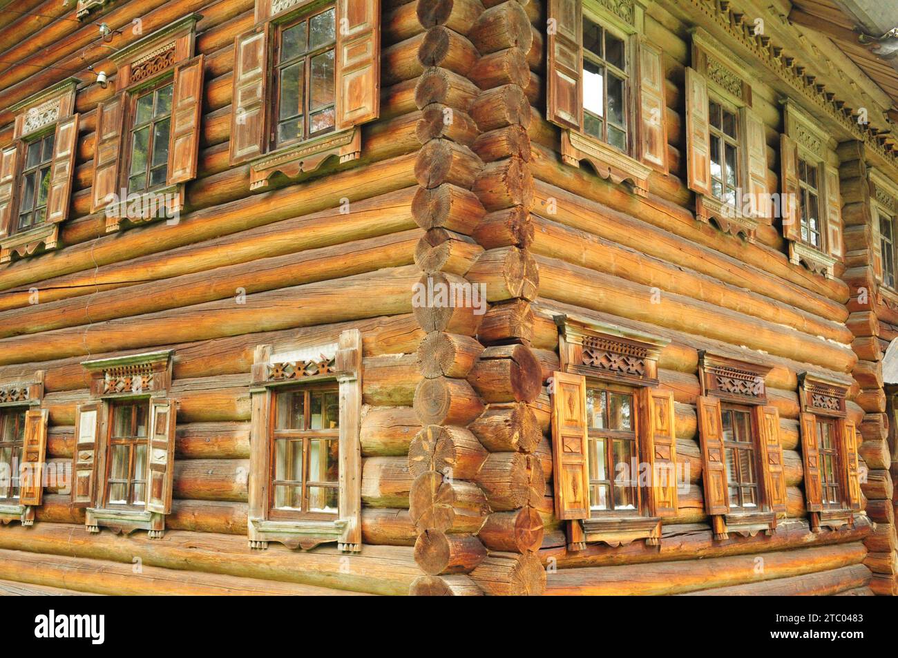 Corner of a twostory wooden house in Russian national style Stock