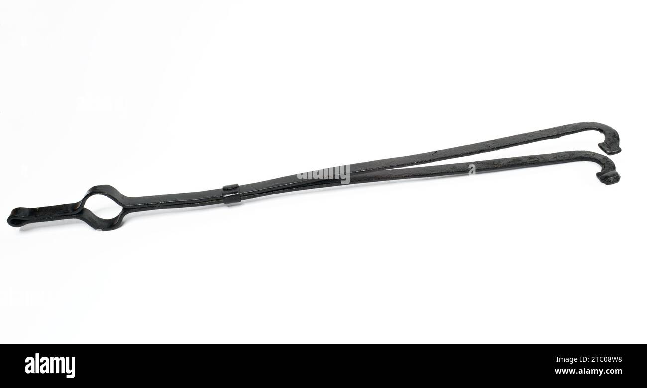 Black fire tongs made of cast iron Stock Photo Alamy