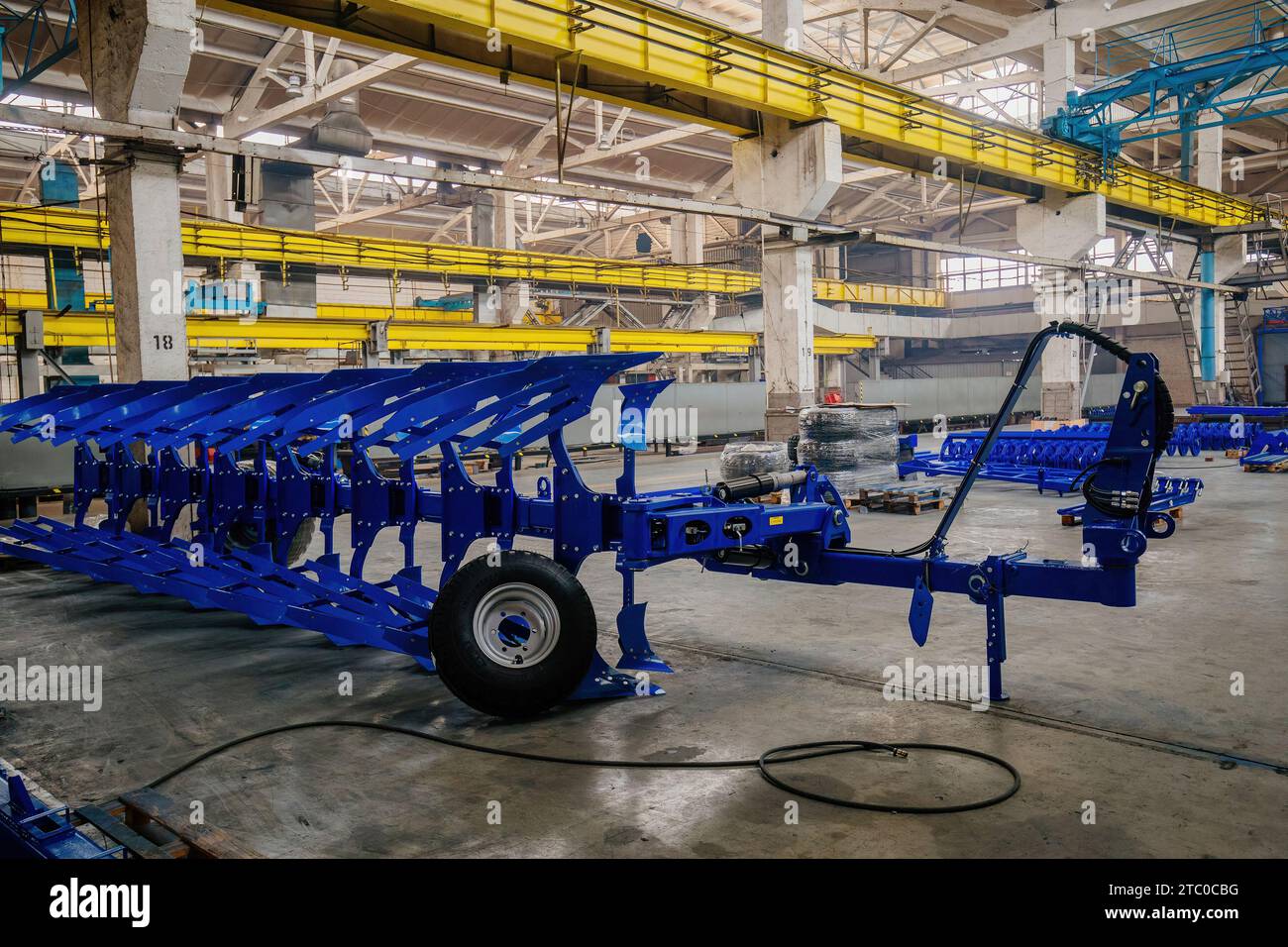 Modern manufactured agricultural reversible plow in factory Stock Photo