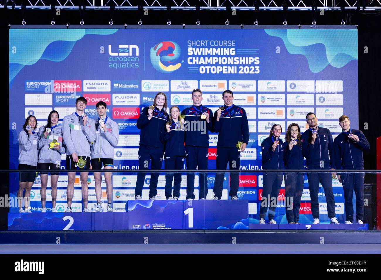 Gold medalists, Proud Benjamin, Burras Lewis, Hopkin Anna and Anderson Freya of Great Britain, Sliver medalists, Miressi Alessandro, Zazzeri Lorenzo, Nocentini Jasmine and di Pietro Silvia of Italy and Bronze medalists, Grousset Maxime, Manaudou Florent, Bonnet Charlotte and Gastaldello Beryl of France during the podium ceremony for Mixed 4x50m Freestyle at the LEN Short Course European Championships 2023 on December 9, 2023 in Otopeni, Romania Stock Photo