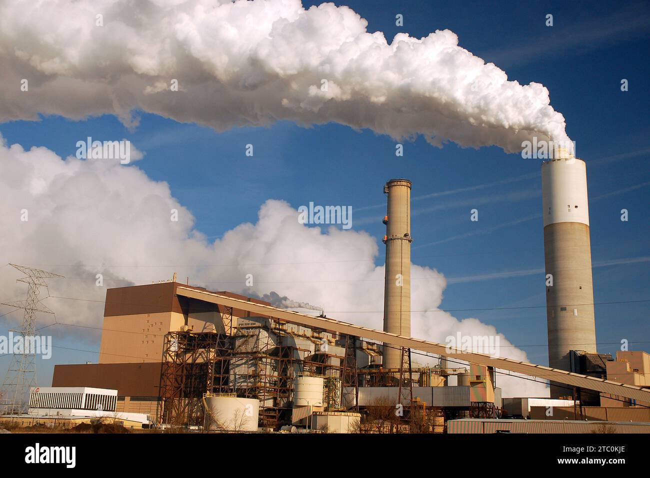 Pollution billows into the sky creating an environmental hazard affecting climate change and global warming Stock Photo