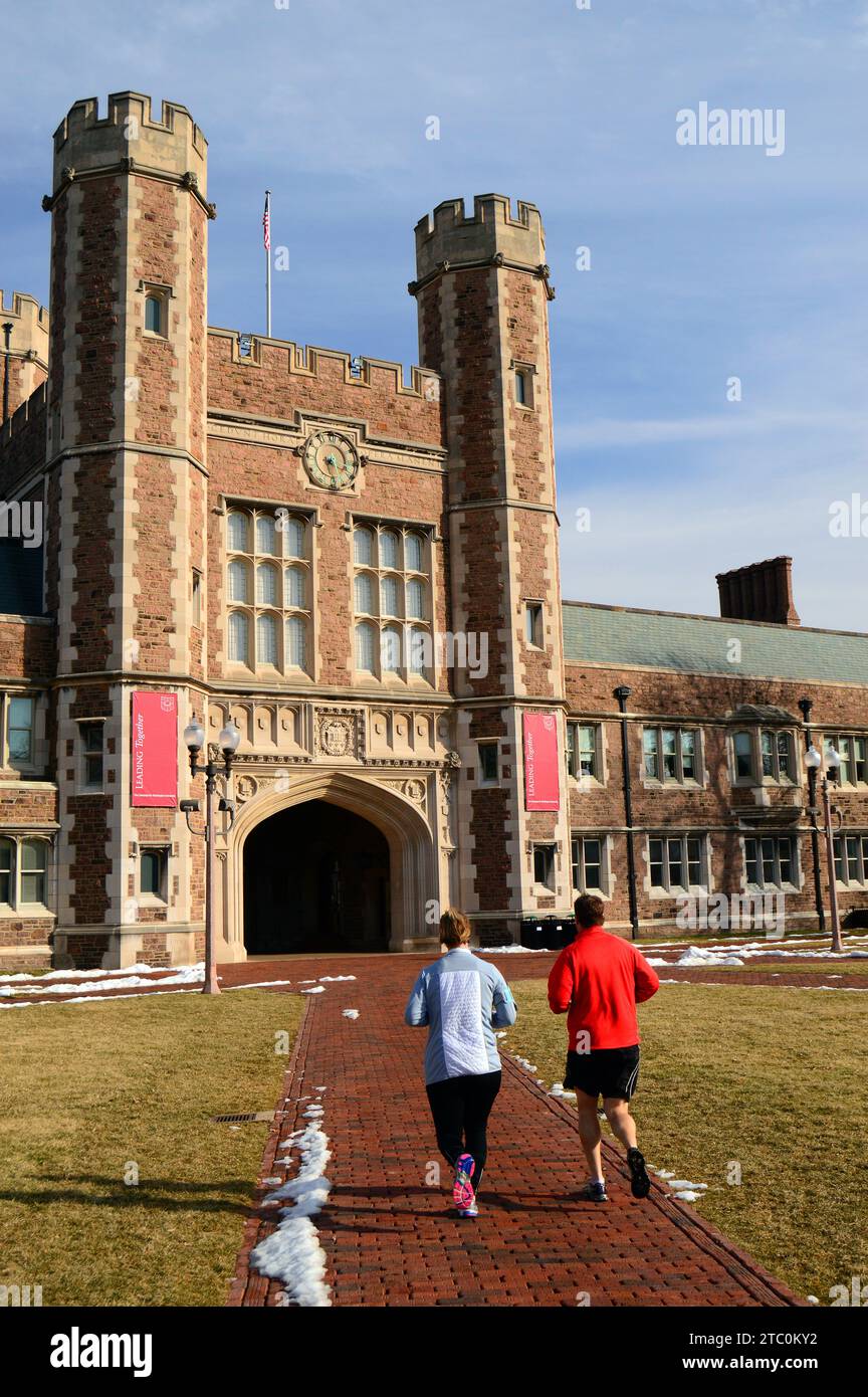 Two joggers run through the main campus of Washington University in St Louis Missouri Stock Photo