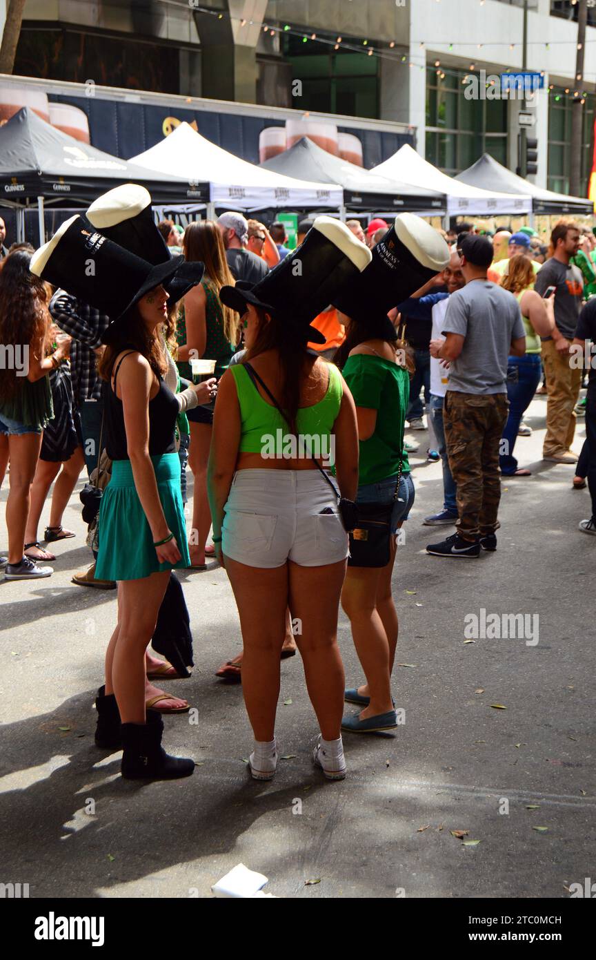A group of friends celebrate St Patrick's Day wearing green and drinking beer in downtown Los Angeles Stock Photo