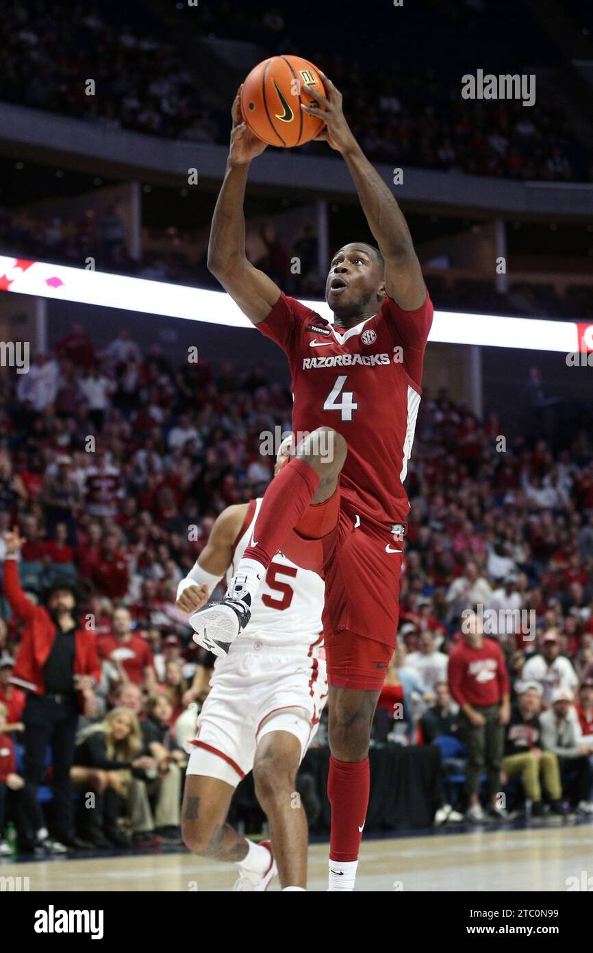 Arkansas guard Davonte Davis (4) goes up for a dunk during the first