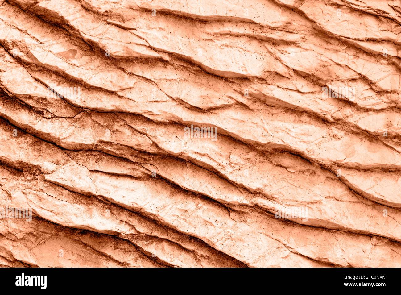 Peachy rock or stone surface. Background, texture. Color of the year 2024 - Peach Fuzz. Stock Photo