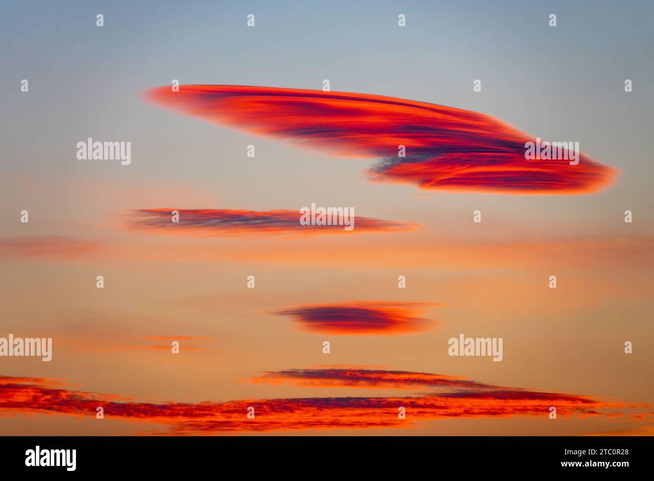 Beautiful lenticular clouds in the sky at sunset Stock Photo