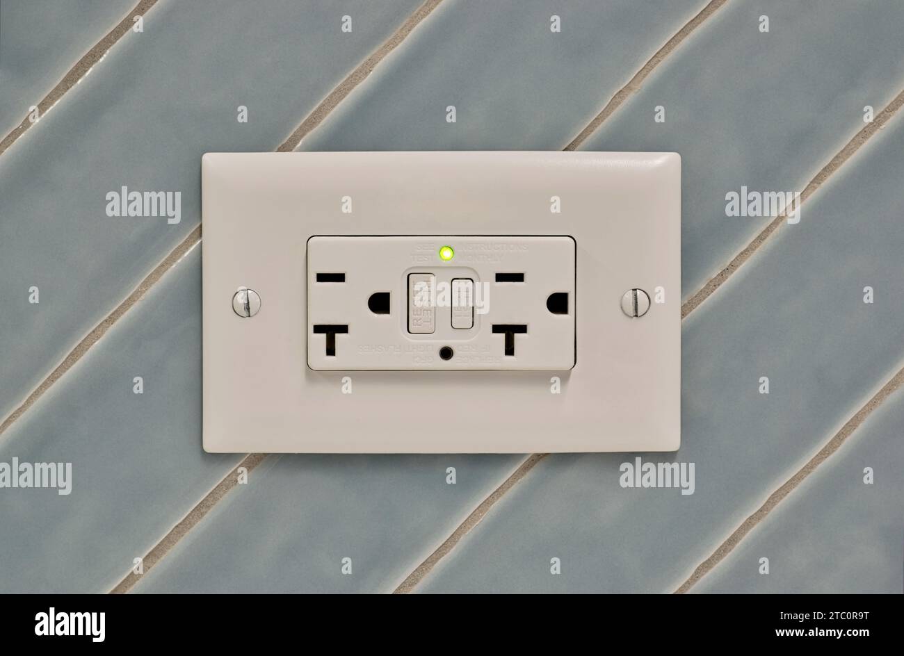 Twin power outlet duplex socket on a tiled wall, USA NEMA 515