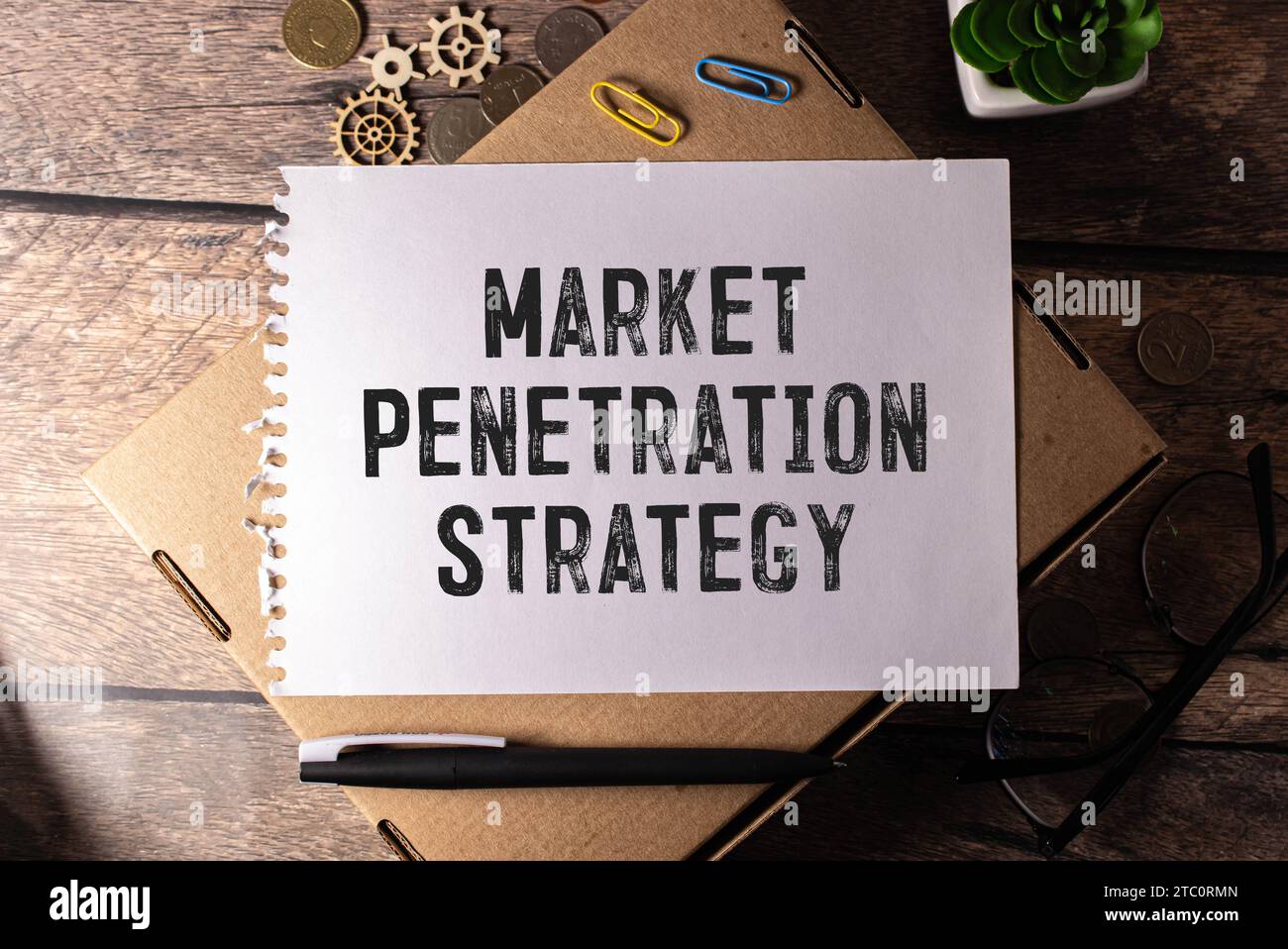 Business and finance concept. On the table is a notebook, a pen and a business card with the inscription - MARKET PENETRATION. Stock Photo