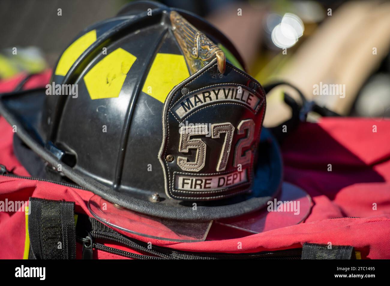 A fire helmet atop a firefighter's gear bag. Stock Photo