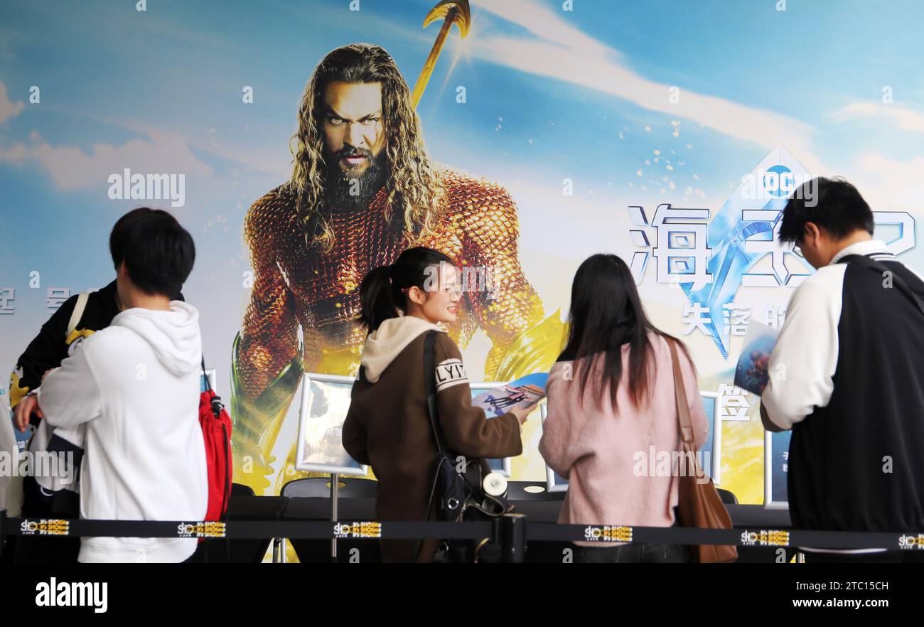 Shanghai, China. 09th Dec, 2023. Fans are standing in front of a poster of the film 'Aquaman and The Lost Kingdom' at a cinema in Shanghai, China, on December 9, 2023. (Photo by Costfoto/NurPhoto) Credit: NurPhoto SRL/Alamy Live News Stock Photo