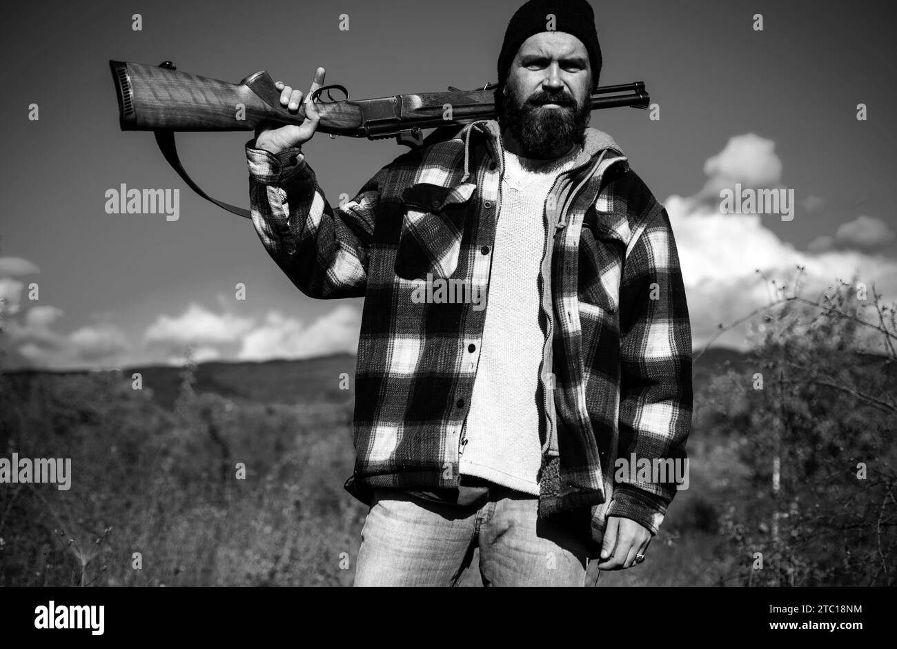 Clothes for the hunter. Hunter with shotgun gun on hunt. Man holding