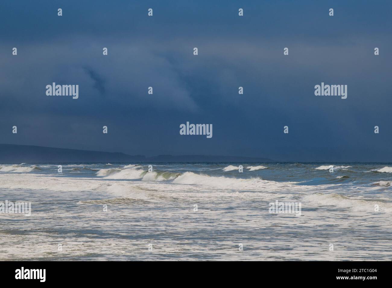 Rolling waves and dark skies from Findhorn beach. Findhorn, Morayshire, Scotland Stock Photo