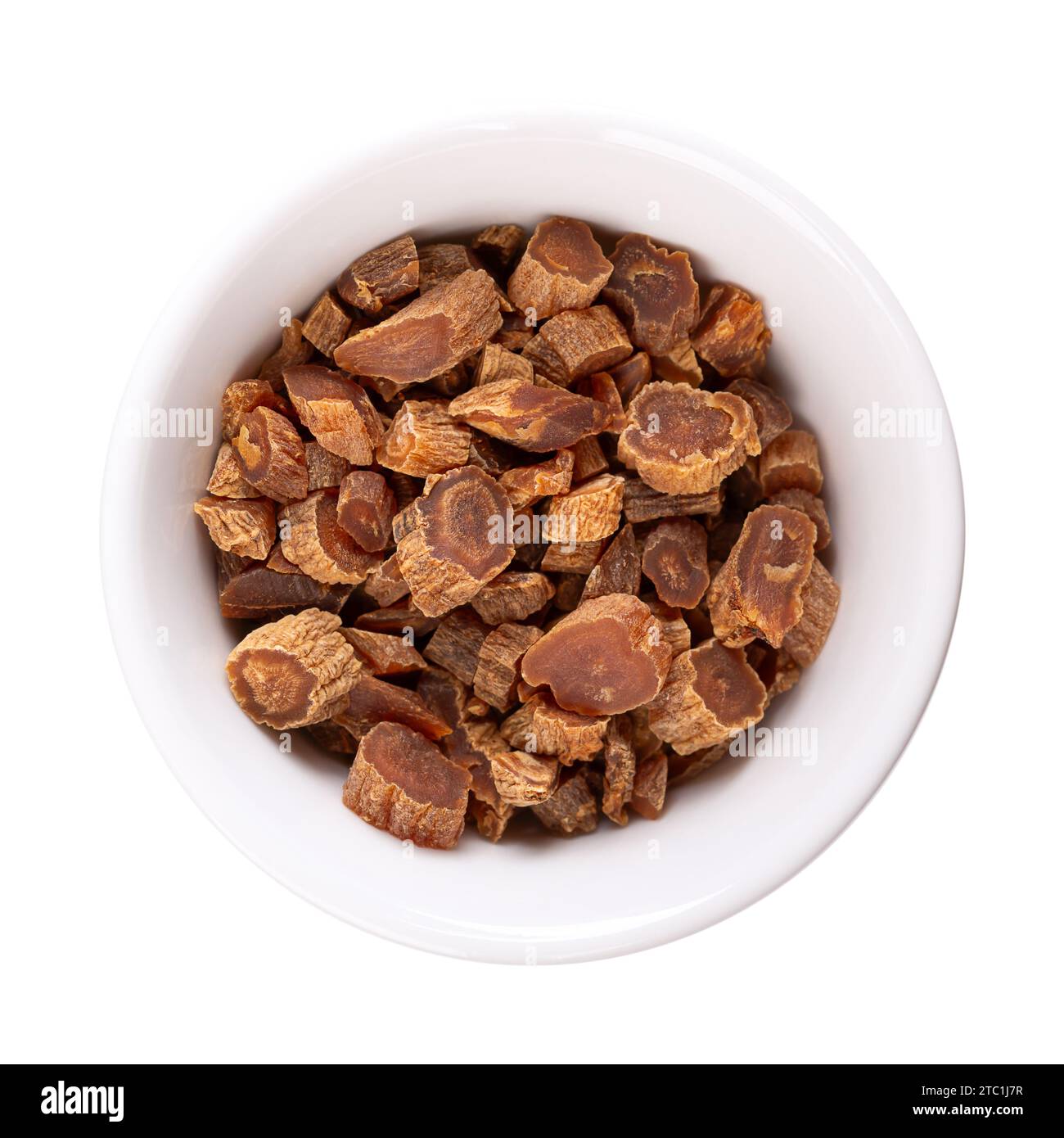 Dried cut red Korean ginseng root in a white bowl. Panax ginseng, also known as Asian or Chinese ginseng. Used as an herb in folk medicine. Stock Photo
