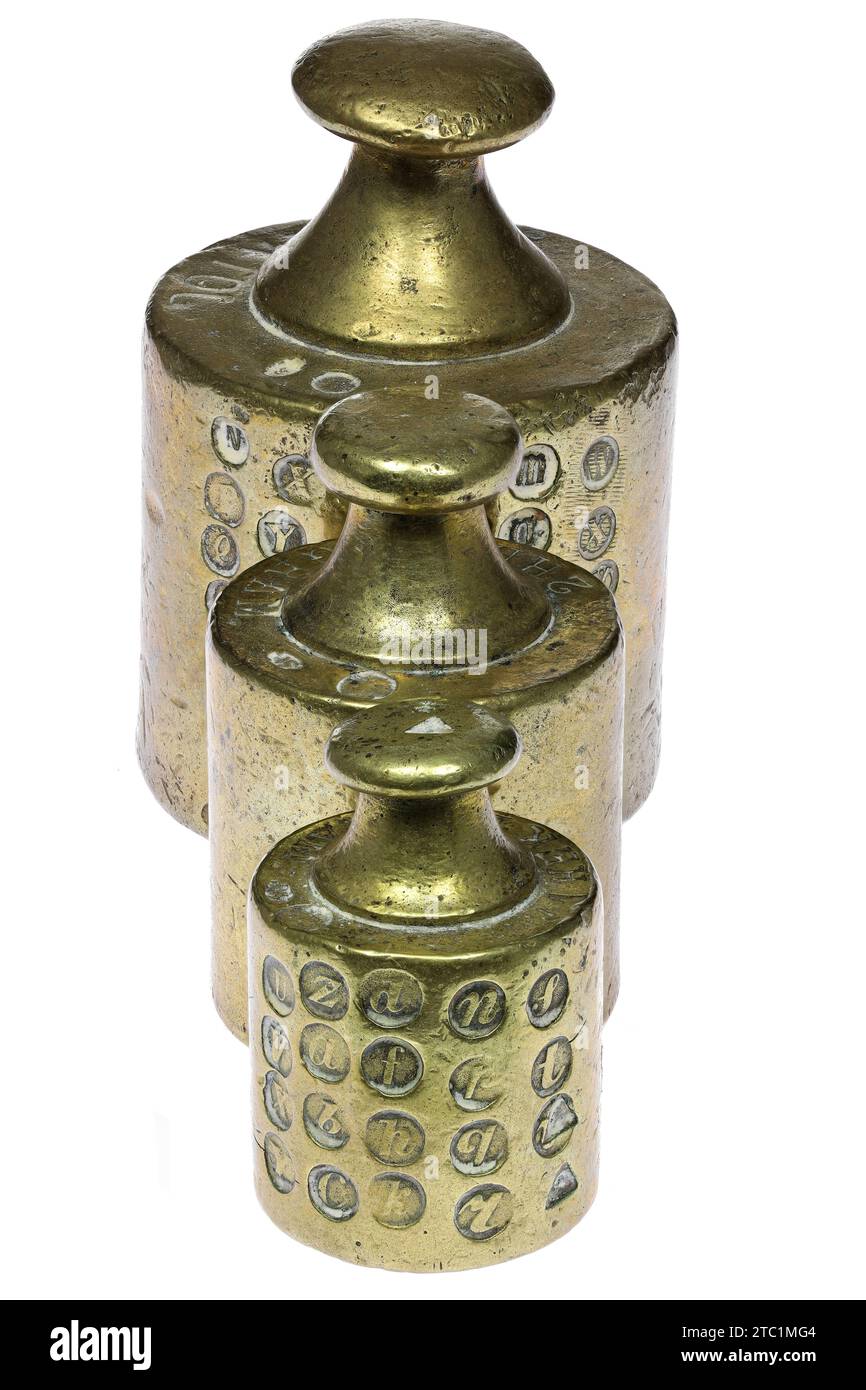 vintage brass weights with several calibration hallmarks isolated on