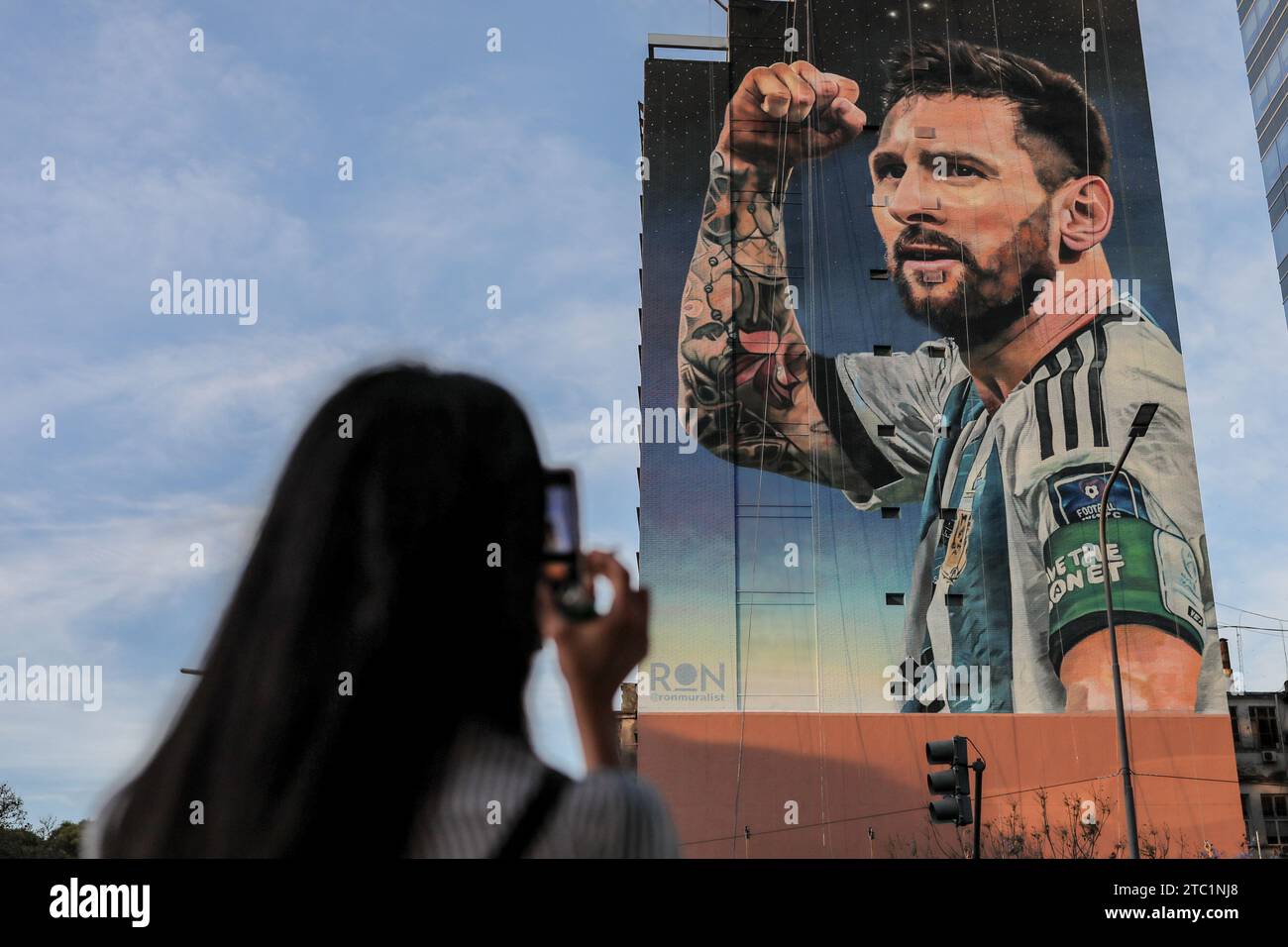 A woman takes a photo of a mural of the Lionel Messi soccer team before the change of government amid economic and social upheaval. President-elect Javier Milei of La Libertad Avanza, a far-right libertarian who burst onto the Argentine political scene with eccentric and radical proposals, will take office on Sunday, December 10, replacing incumbent Peronist Alberto Fernández. Milei describes himself as an 'anarcho-capitalist' libertarian who wants to drastically reduce the size of the state and replace the local peso with the US dollar. The new administration will face the challenge of reduci Stock Photo