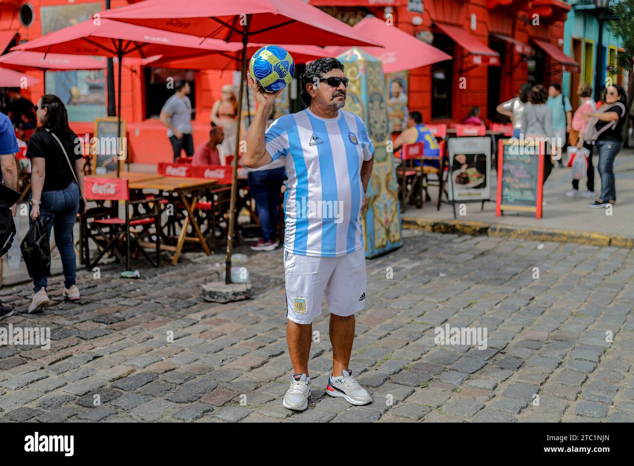 A man dressed as the late Argentine soccer player, Diego Maradona, walks through the 'caminitos' sector before the change of government amid economic and social upheaval. President-elect Javier Milei of La Libertad Avanza, a far-right libertarian who burst onto the Argentine political scene with eccentric and radical proposals, will take office on Sunday, December 10, replacing incumbent Peronist Alberto Fernández. Milei describes himself as an 'anarcho-capitalist' libertarian who wants to drastically reduce the size of the state and replace the local peso with the US dollar. The new administr Stock Photo