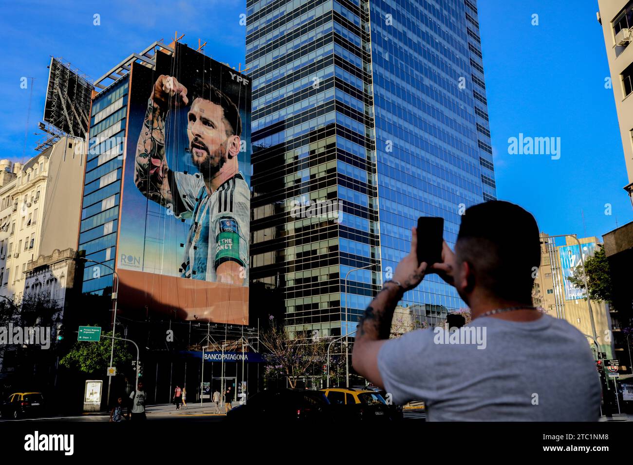 A man takes a photo of a mural of the Lionel Messi soccer team before the change of government amid economic and social upheaval. President-elect Javier Milei of La Libertad Avanza, a far-right libertarian who burst onto the Argentine political scene with eccentric and radical proposals, will take office on Sunday, December 10, replacing incumbent Peronist Alberto Fernández. Milei describes himself as an 'anarcho-capitalist' libertarian who wants to drastically reduce the size of the state and replace the local peso with the US dollar. The new administration will face the challenge of reducing Stock Photo