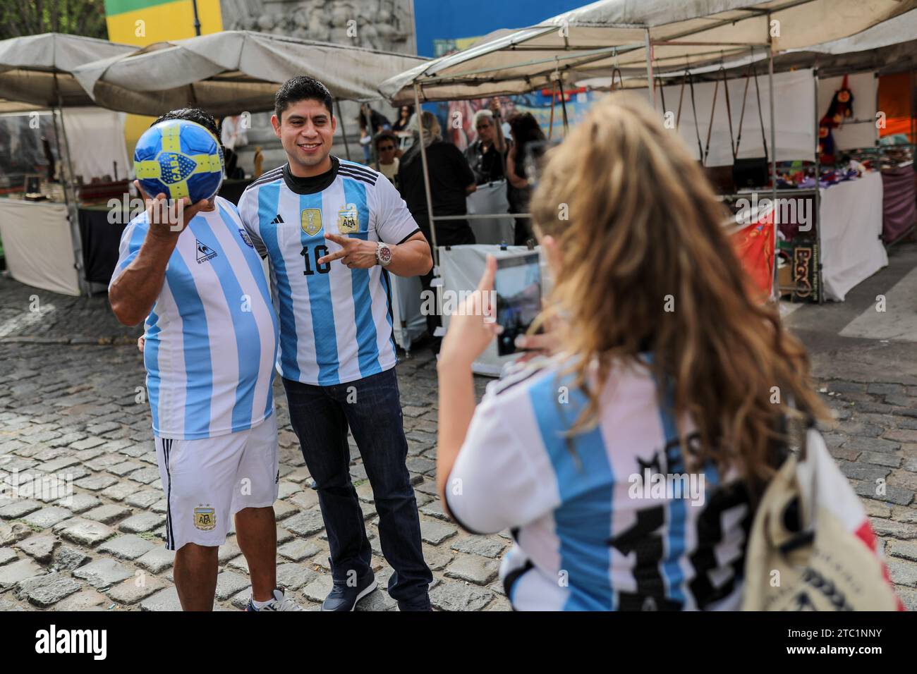 A man dressed as the late Argentine soccer player, Diego Maradona, takes photos with tourists in the 'caminitos' sector before the change of government amid economic and social upheaval. President-elect Javier Milei of La Libertad Avanza, a far-right libertarian who burst onto the Argentine political scene with eccentric and radical proposals, will take office on Sunday, December 10, replacing incumbent Peronist Alberto Fernández. Milei describes himself as an 'anarcho-capitalist' libertarian who wants to drastically reduce the size of the state and replace the local peso with the US dollar. T Stock Photo
