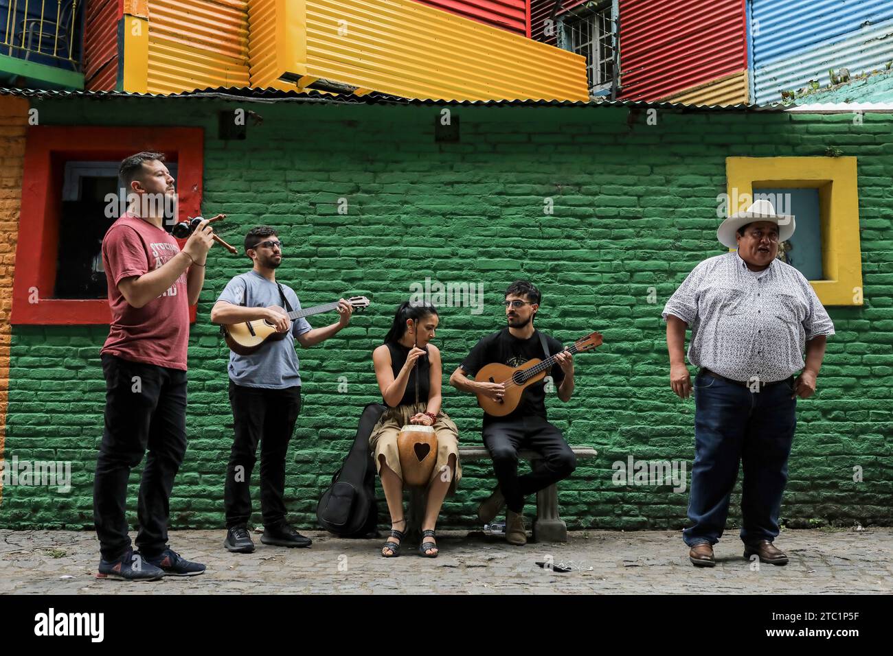 People sing in 'La Boca', before the change of government amid economic and social upheaval. President-elect Javier Milei of La Libertad Avanza, a far-right libertarian who burst onto the Argentine political scene with eccentric and radical proposals, will take office on Sunday, December 10, replacing incumbent Peronist Alberto Fernández. Milei describes himself as an 'anarcho-capitalist' libertarian who wants to drastically reduce the size of the state and replace the local peso with the US dollar. The new administration will face the challenge of reducing the country's 140% annual inflation Stock Photo