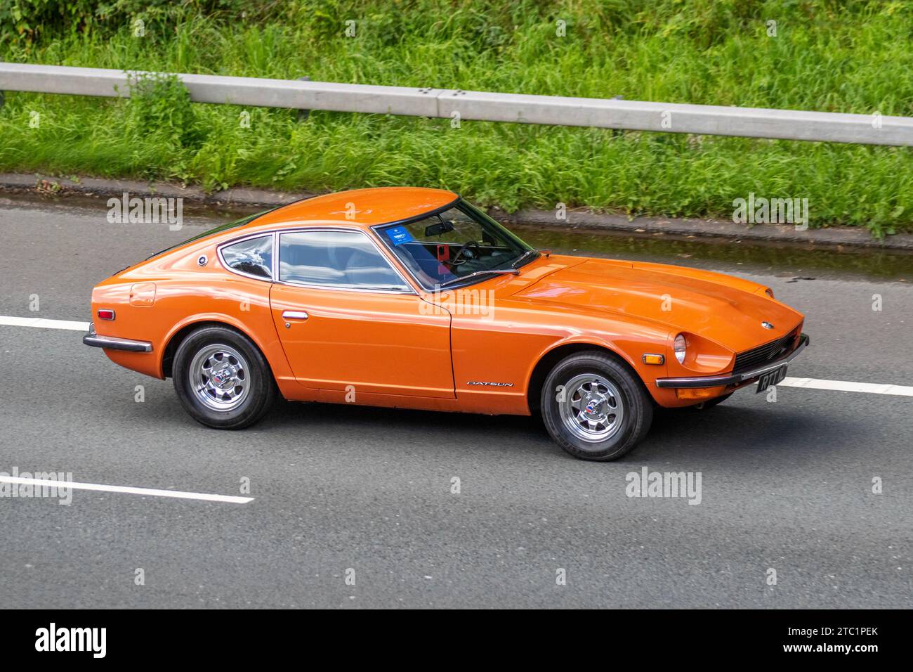 1973 70s seventies Orange Datsun 240Z; Vintage, restored classic motors, automobile collectors motoring enthusiasts, historic veteran cars travelling in Greater Manchester, UK Stock Photo