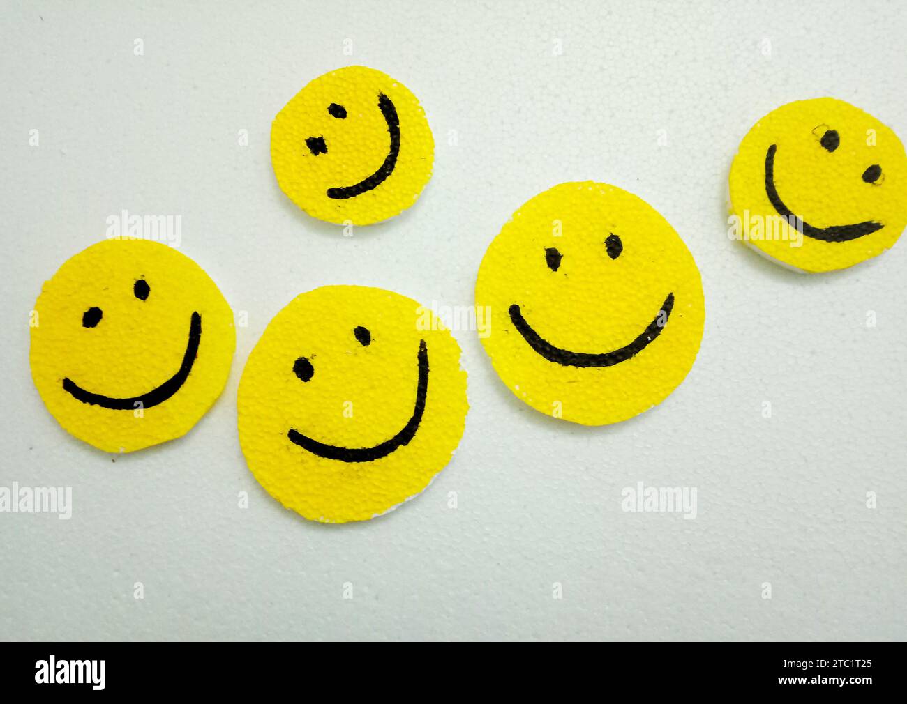 Crafted smiley face icons against white background. Happy, joy, smiling, positive vibes, together, fellowship, love and group of happy people concepts Stock Photo
