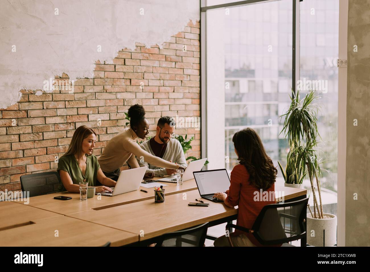 Young multiethnic startup team working at the rustic office Stock Photo