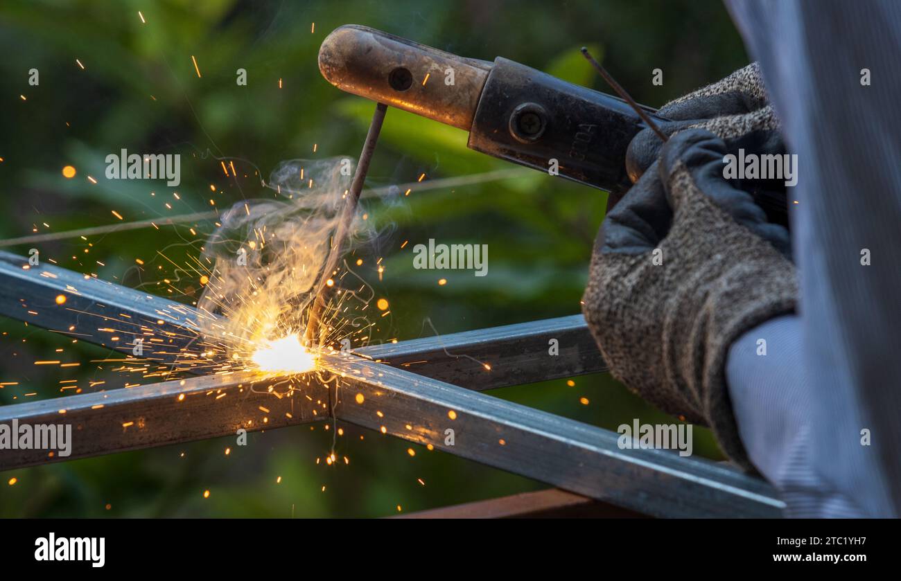 Blue spark of shielded metal arc welding with smoke and sparkling Stock