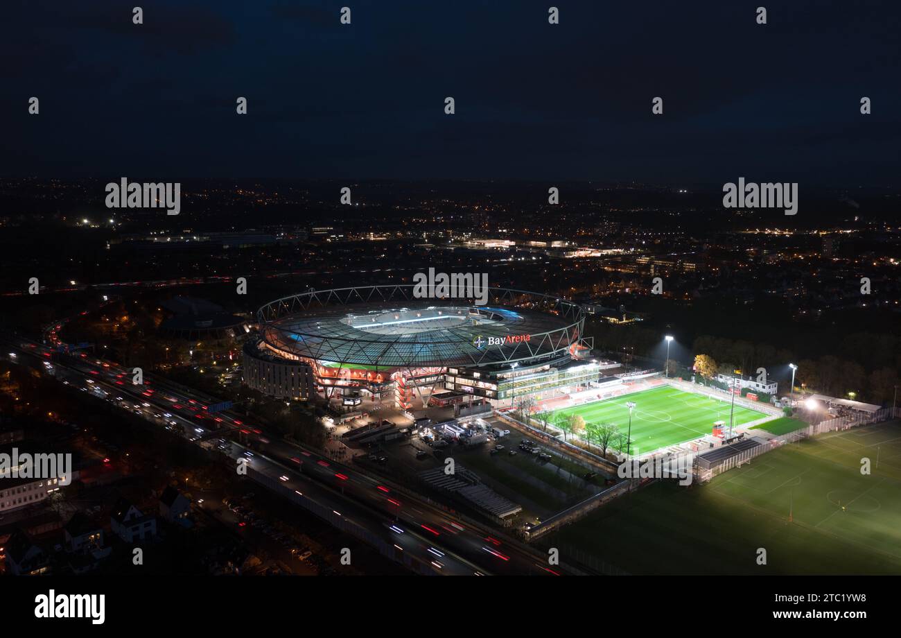 Leverkusen, North Rhine-Westphalia, Germany - November, 2023: Aerial night panorama view of the illuminated BayArena, home stadium of Bundesliga footb Stock Photo