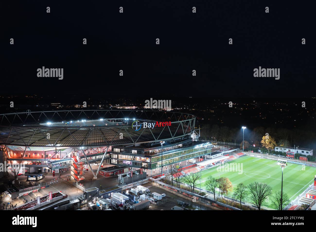 Leverkusen, North Rhine-Westphalia, Germany - November, 2023: Aerial night panorama view of the illuminated BayArena, home stadium of Bundesliga footb Stock Photo