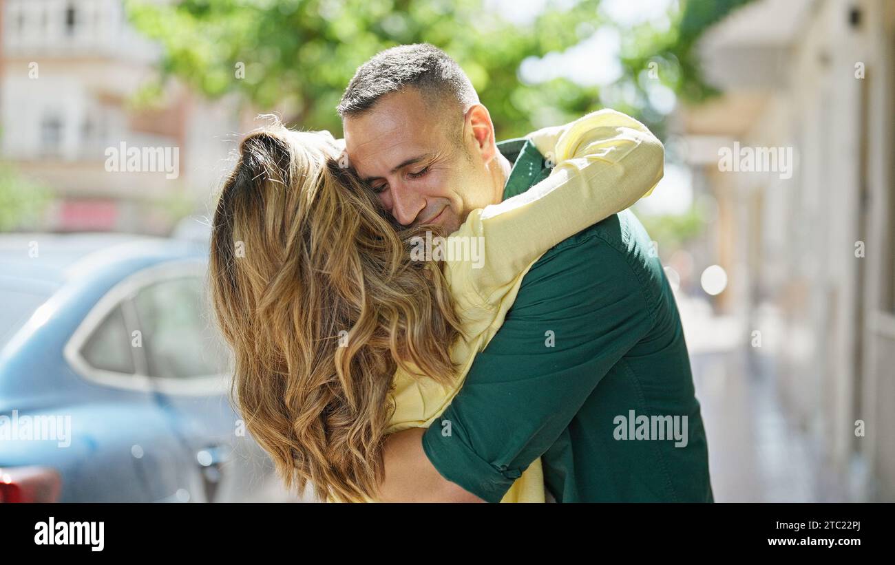 Man and woman couple hugging each other smiling at street Stock Photo ...