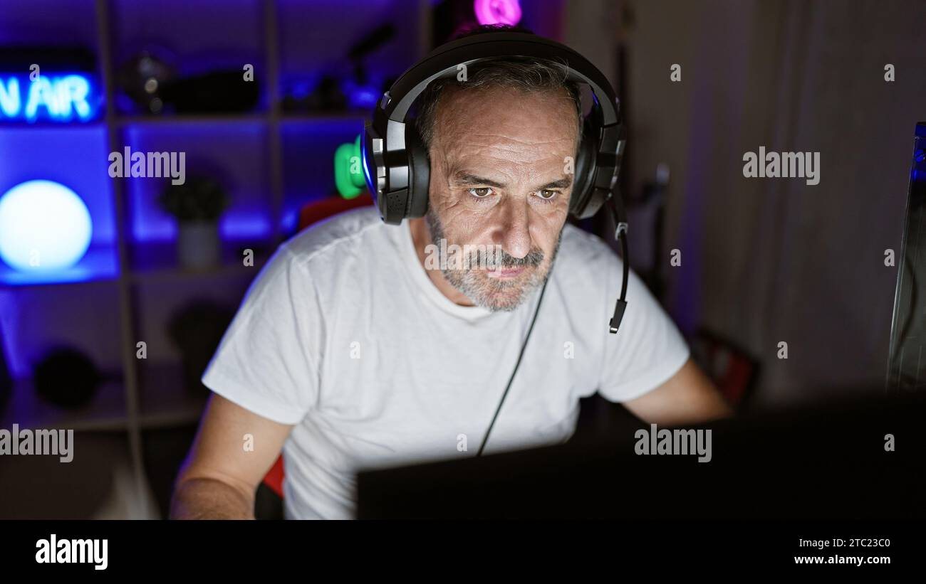 Serious-faced, middle-aged streamer with grey hair, immersed in a night
