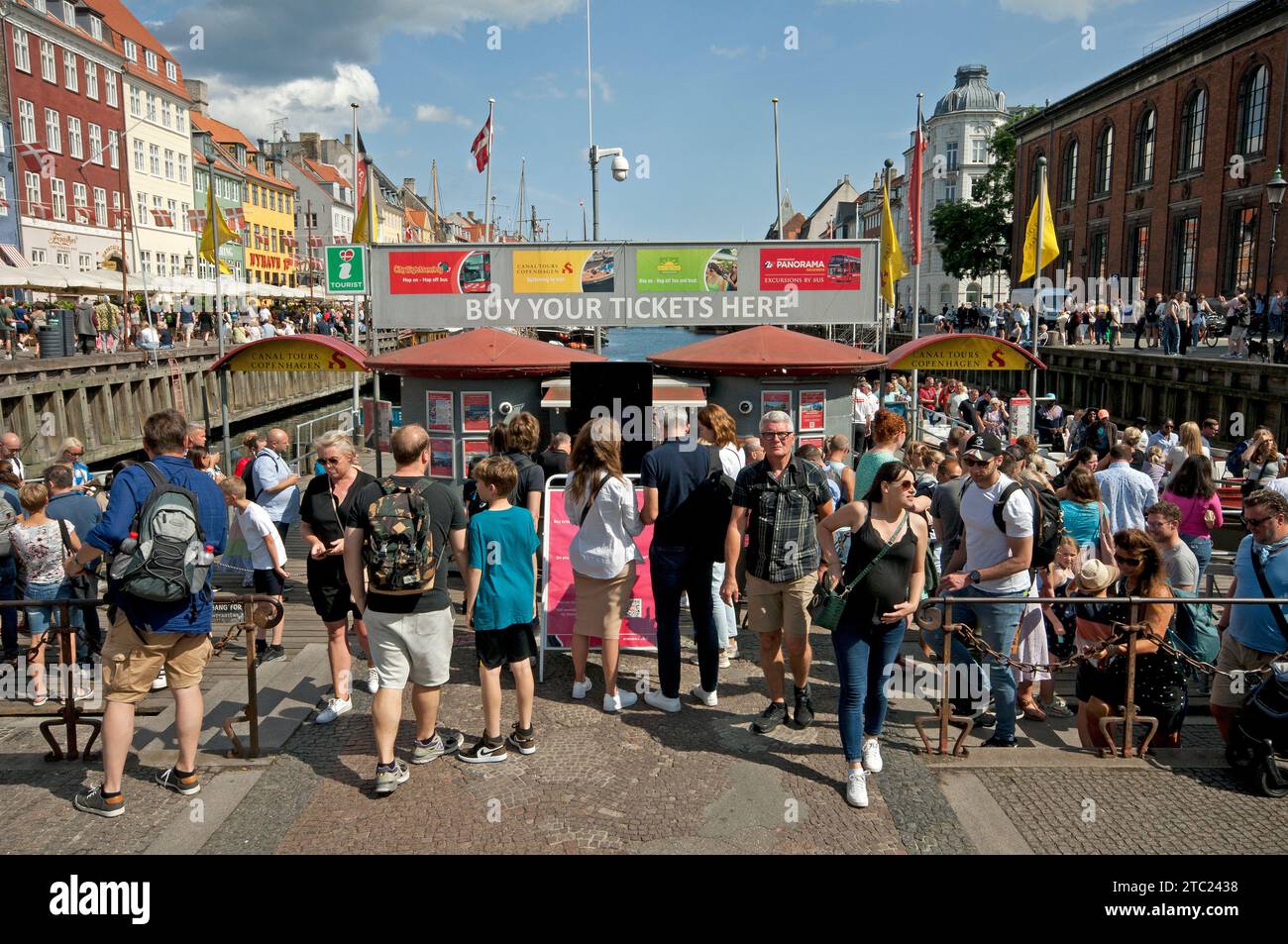 Crowd of tourists at ticket office for sightseeing boat tours, Nyhavn canal, Copenhagen, Denmark Stock Photo
