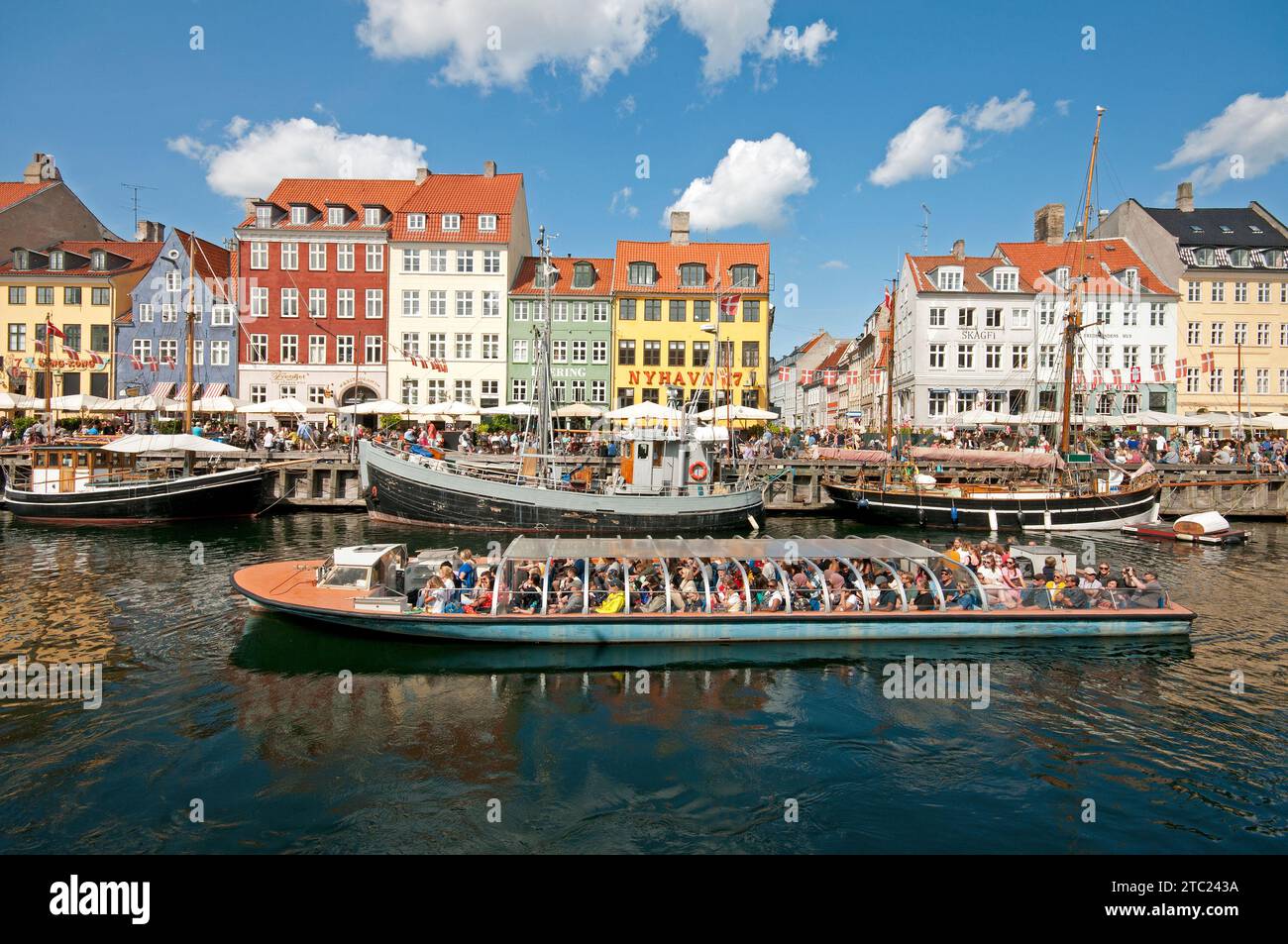 Sightseeing boat tour on the Nyhavn canal, Copenhagen, Denmark Stock Photo