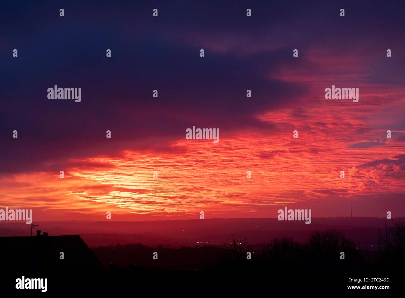 West Yorkshire, UK. 10th Dec, 2023. UK Weather. Northowram, West Yorkshire, UK.  A stunning sunrise after Storm Elin over the Pennines seen from the village of Northowram near Halifax, West Yorkshire with the Grade 2 listed transmitter of Emley Moor on the skyline. Credit: Windmill Images/Alamy Live News Stock Photo