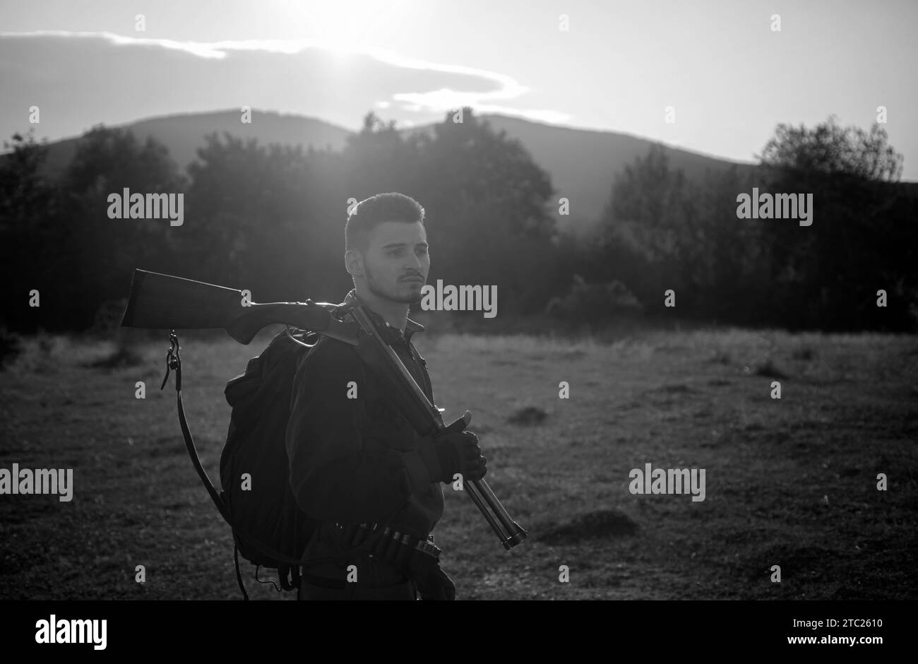 Rifle Hunter Silhouetted in Beautiful Sunset. Autumn hunting season