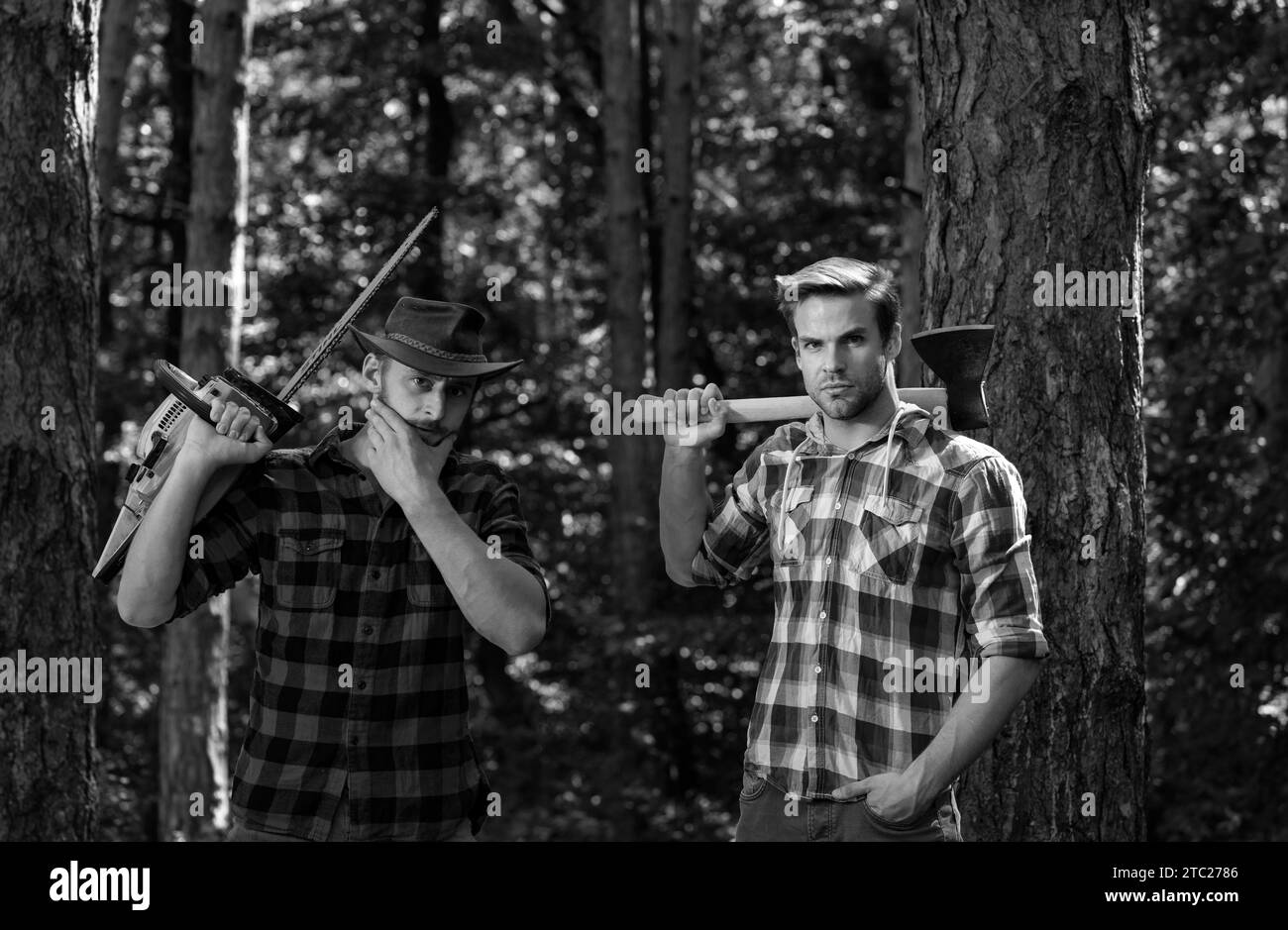 Foresters men. Man with serious face carries axe. Lumberjack brutal holds axe. Brutal lumberjack concept. Stock Photo