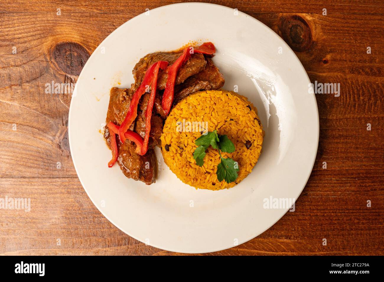 Steak and peppers with yellow rice Stock Photo - Alamy