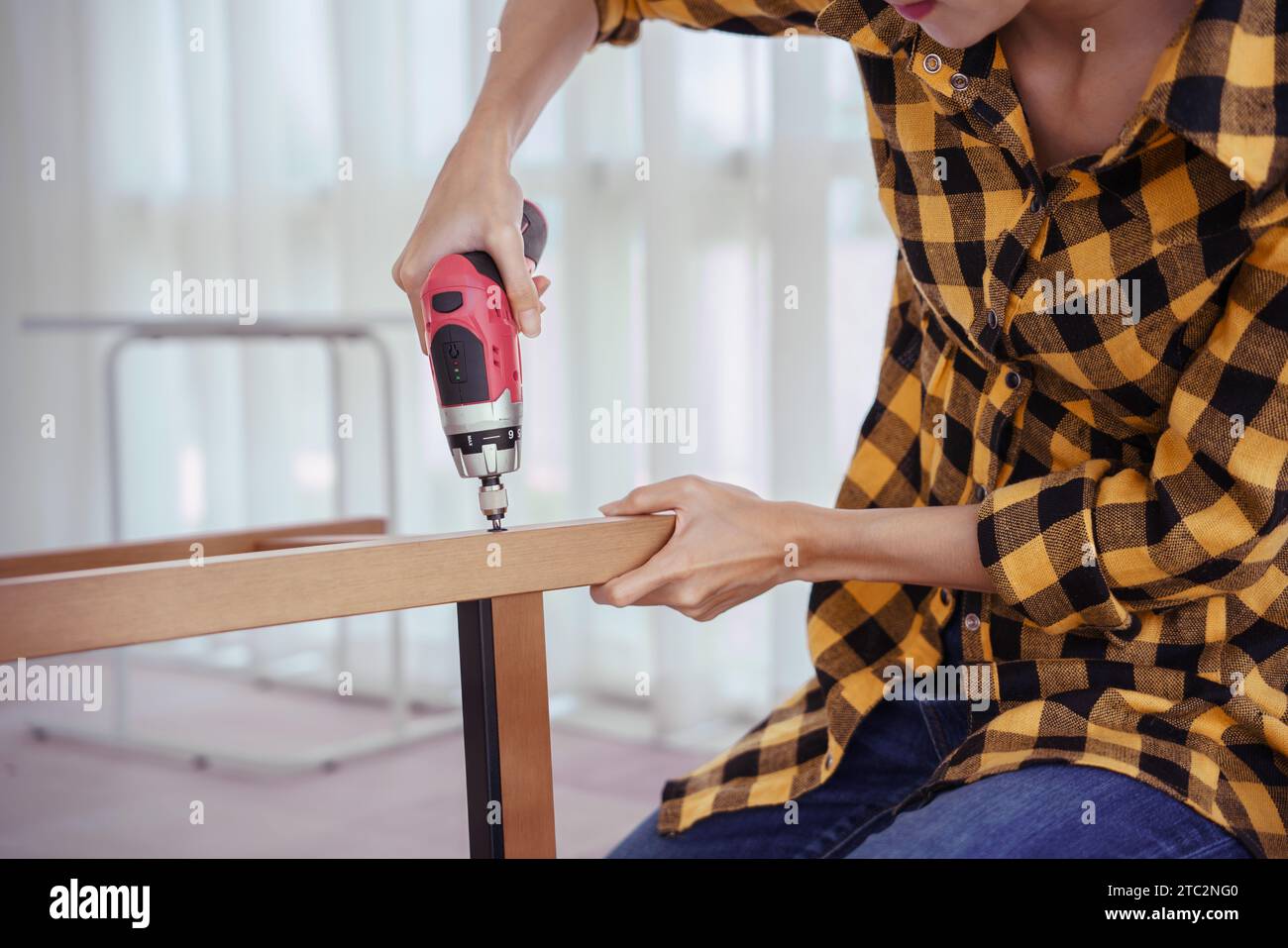 Women use electric screwdriver to installation screw and assembling ...
