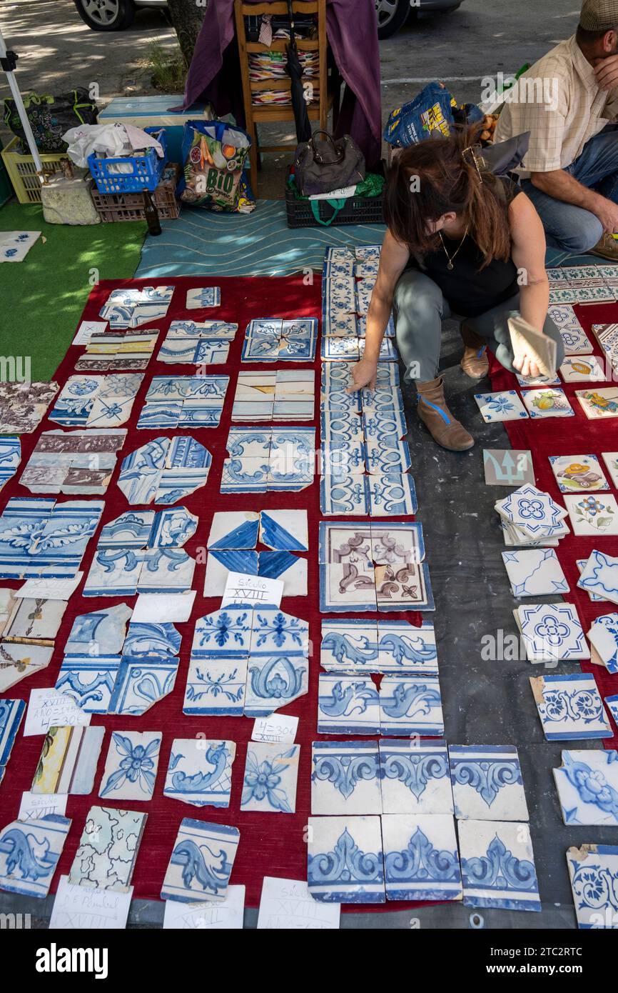 stall selling azulejos ancient traditional painted tiles at the Sunday flea market, Feira da Ladra (thief fair) at campo de Santa Clara Lisbon Portuga Stock Photo