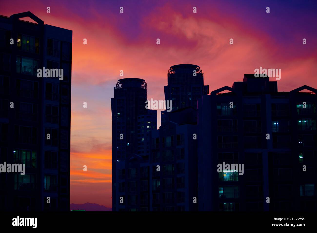 Ulsan's sky at sunset, with dark apartment silhouettes, vibrant sky. Stock Photo