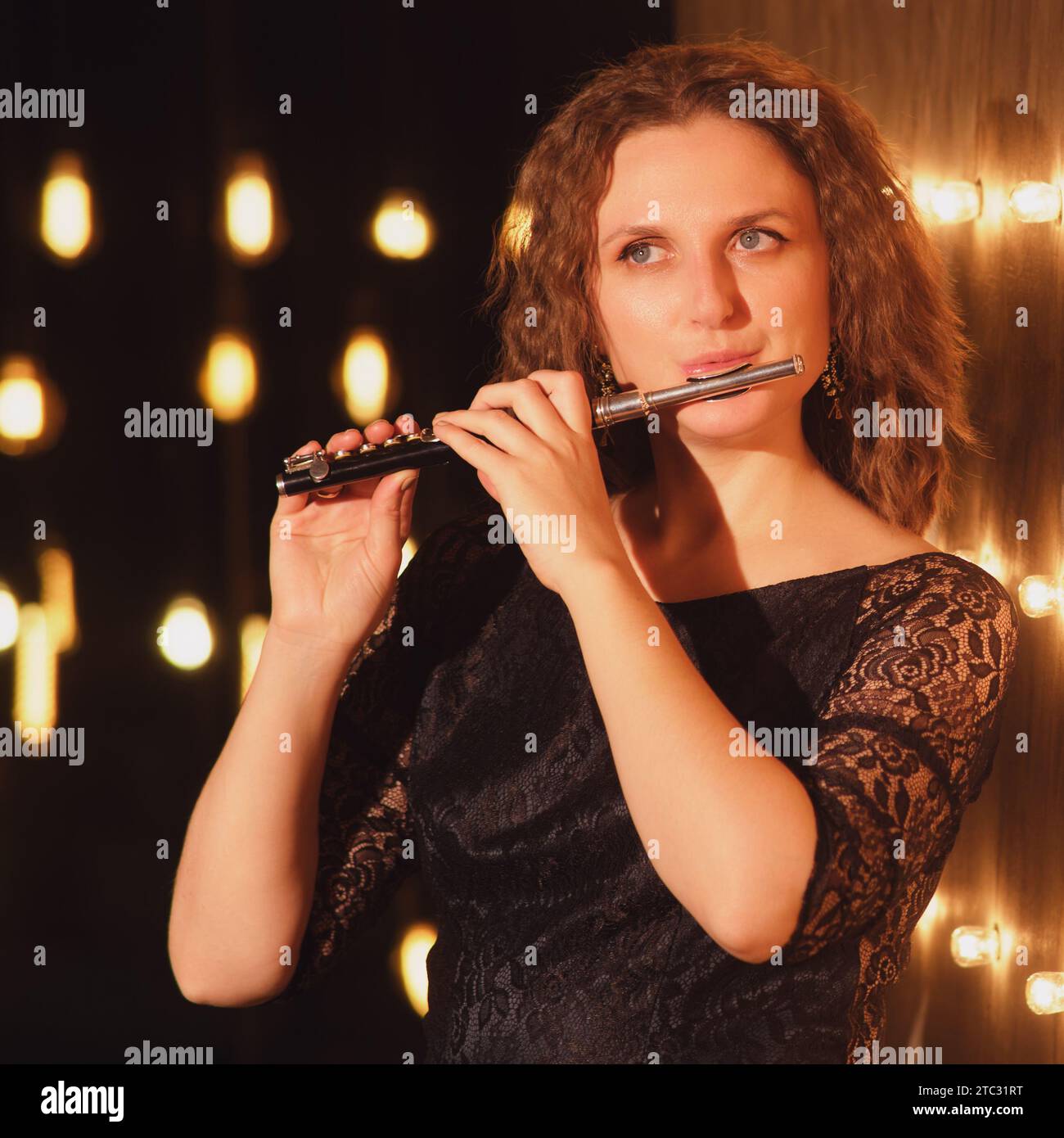 The female flautist, an accomplished musician, lit up the stage with ...